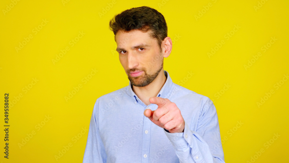 You. Bearded man presses an imaginary button on a yellow background with copyspace. Handsome guy in a light blue shirt. Place for graphics, text or product You. Bearded man presses an imaginary button on a yellow background with copyspace. Handsome guy in a light blue shirt. Place for graphics, text or product