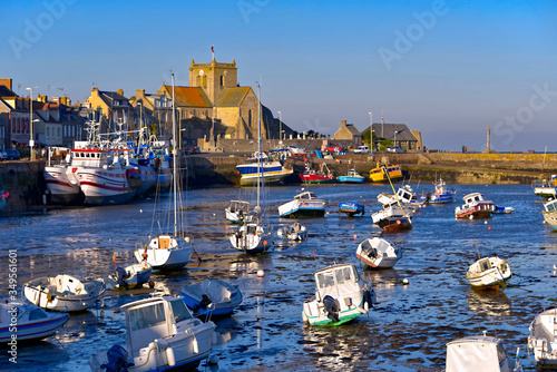 Port at low tide at the end of the sunny day and church of Saint-Nicolas of Barfleur, a commune in the peninsula of Cotentin in the Manche department
in Lower Normandy in north-western France