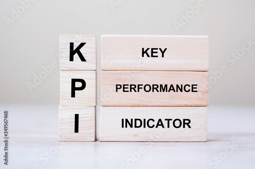 wooden cube block with KPI (KEY, Performance and Indicator) word on table background. Business concept photo