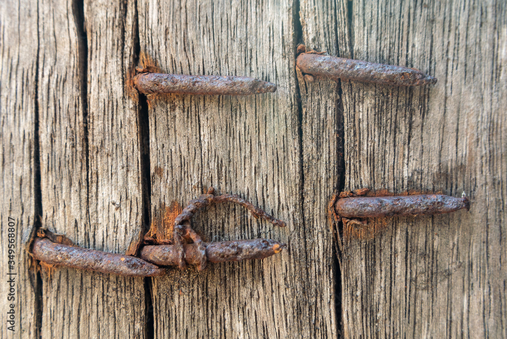 Nails that pierce wood are rusting. Nails that pierce wood are rusting.