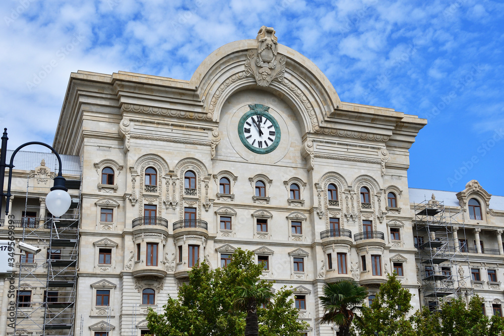Fototapeta premium Fragment of beautiful historical building with a clock on Fuzuli street. Azerbaijan, Baku city