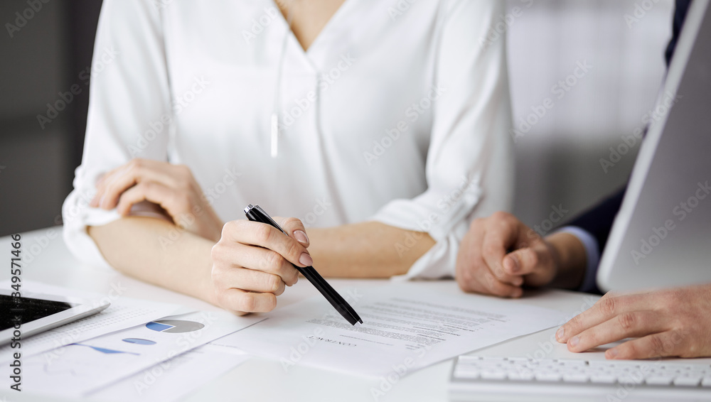 Fototapeta premium Unknown businessman and woman discussing contract in office. closeup.Business people or lawyers working together at meeting. Teamwork and partnership