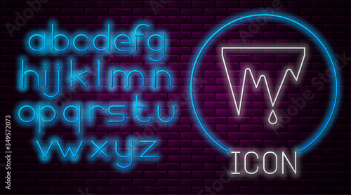Glowing neon line Icicle icon isolated on brick wall background. Stalactite, ice spikes. Winter weather, snow crystals. Neon light alphabet. Vector