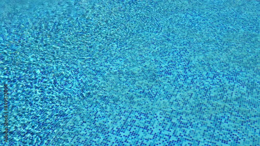 Clean blue water in swimming pool with reflections, nobody Clean blue water in swimming pool with reflections, nobody