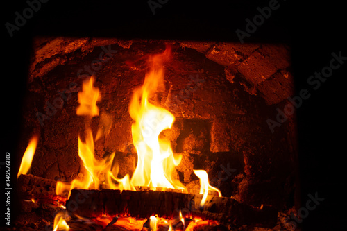 The fire in the Russian stove is burning brightly, creating comfort in the village house