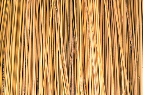 Close up of yellow striped straw texture as background.