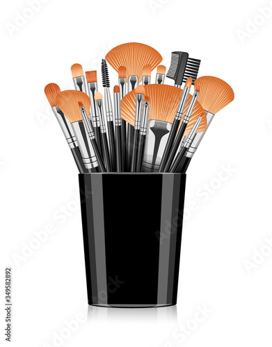 Cosmetic makeup brushes. Brushes in a black glass.