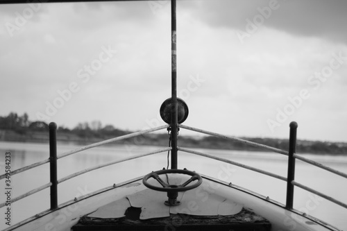 Wooden fishing boat on water during the sunset .Black and white photography