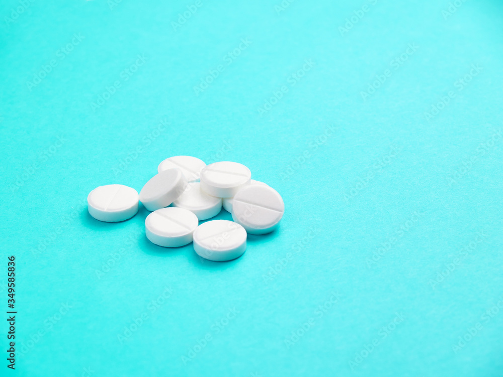 White pills on blue background copy space White pills on blue background copy space