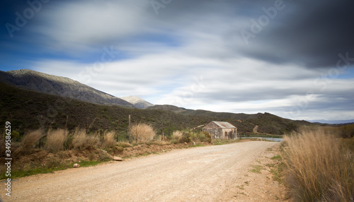 Photography abandoned shed long exposure image with streaky clouds
