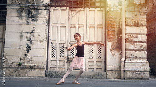 Little ballerina girl dancing along the street © witthaya