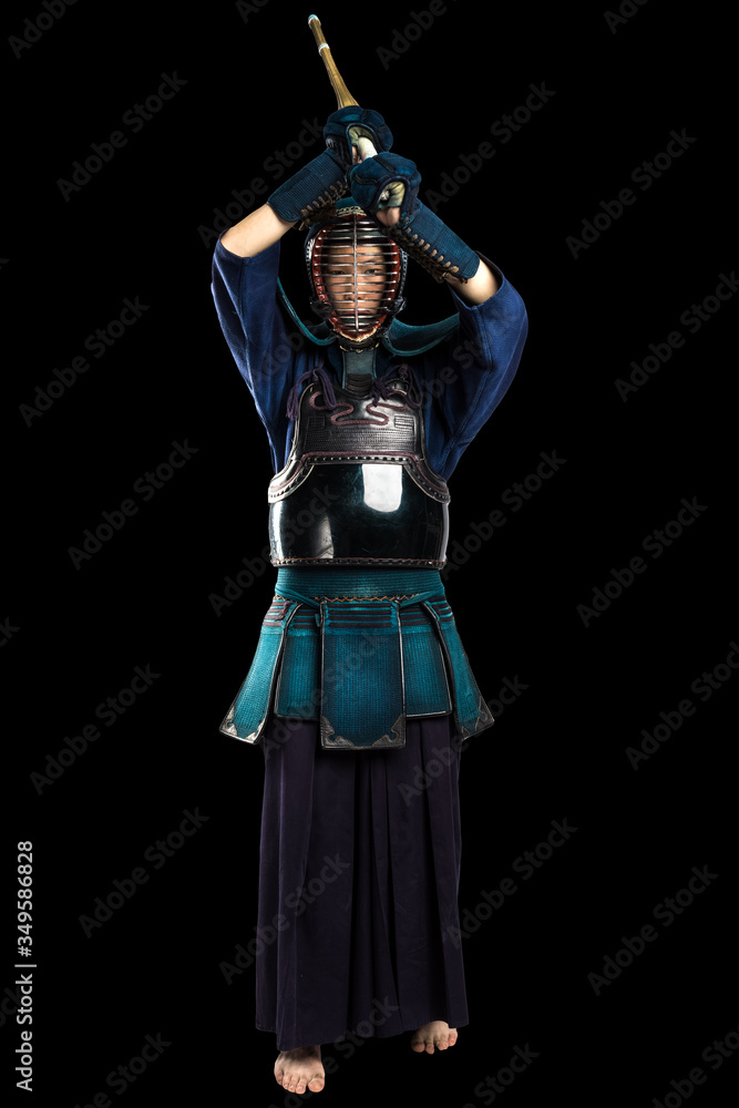 Portrait of man kendo fighter with shinai (bamboo sword). Shot in studio. Isolated with clipping path on black background