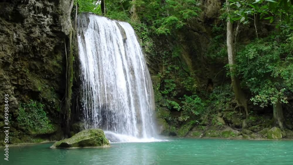 Erawan waterfall third level in National Park, famous tourist destination in Kanchanaburi, Thailand - slow motion Erawan waterfall third level in National Park, famous tourist destination in Kanchanaburi, Thailand - slow motion