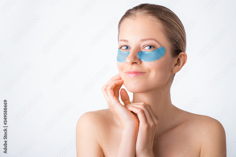 Cosmetology, skin care, face treatment, spa and self-care at home concept. Woman with eye gel pads mask. Cosmetology, skin care, face treatment, spa and self-care at home concept. Woman with eye gel pads mask.