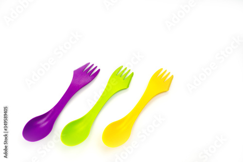 Tourist plastic fork spoon in different colors  photographed large on a white background.