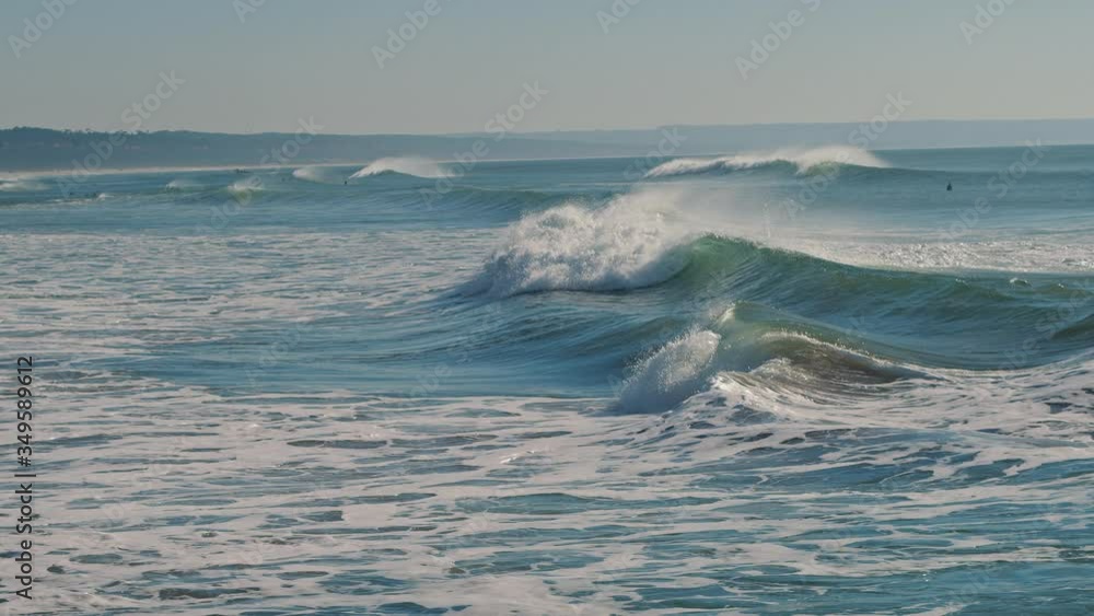 Big splashing ocean waves rush towards the coast on a sunny day. Slow motion, BMPCC 4K. Big splashing ocean waves rush towards the coast on a sunny day. Slow motion, BMPCC 4K.