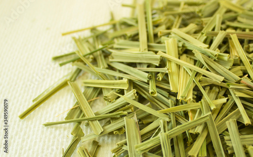 Lemon Grass (Cymbopogon citratus, Capim Limao, Santo). Pile of dried Lemongrass in white bowl. Dried sprigs of natural lemongrass, dried herb, herbal medicine. Selective focus, closeup