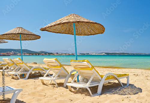 Empty beach chairs on the beach near blue water  Kemer  Turkey 