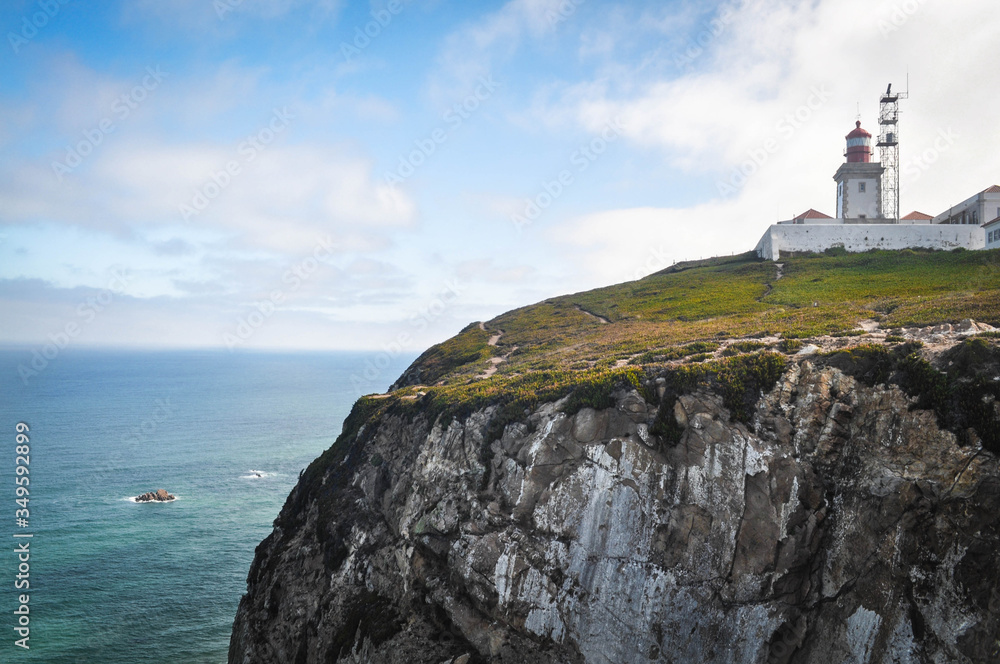 view of the lighthouse which stands cliffs over the ocean.  westernmost point of the europe