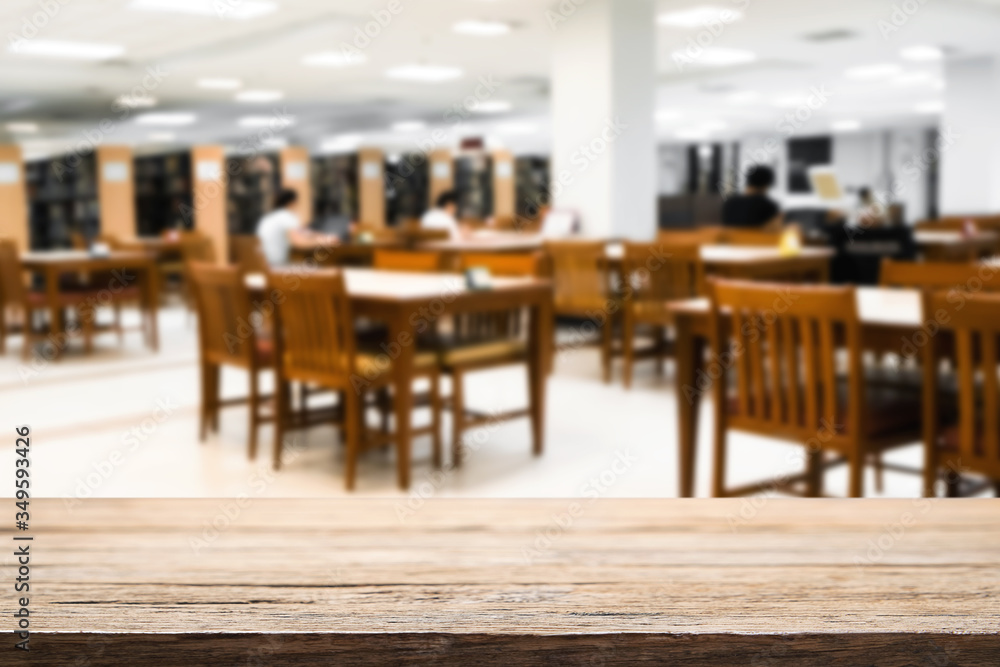 Wooden desk space over blurred office or meeting room background. Product display montage. Wooden desk space over blurred office or meeting room background. Product display montage.