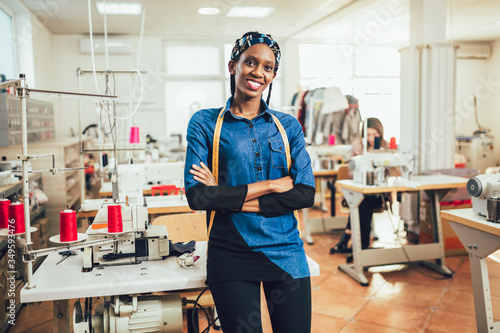 Portrait of happy african dressmaker woman in studio.