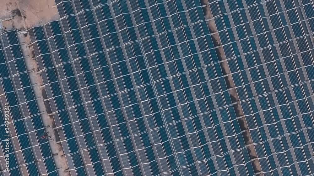 Huge innovative solar farm. Photovoltaic solar panels on the flat roof of the building. Alternative energy. Motion camera around. Aerial view. Huge innovative solar farm. Photovoltaic solar panels on the flat roof of the building. Alternative energy. Motion camera around. Aerial view.
