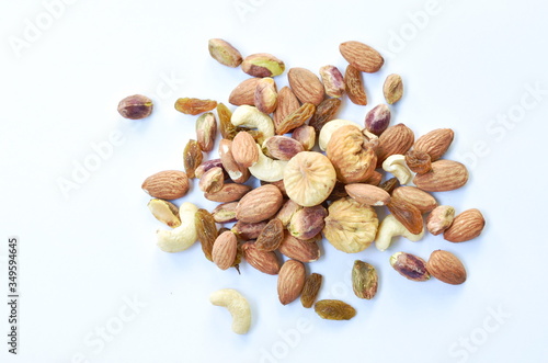 mixed nuts and dry raisin with fig on white background