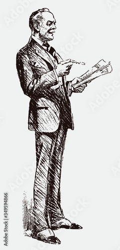 Standing old man from the early 20th century wearing suit and gaiters, holding glasses and reading a newspaper