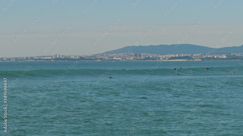 People swimming on surfing boards in the ocean near the Lisbon coast, Portugal. Slow motion, BMPCC 4K. People swimming on surfing boards in the ocean near the Lisbon coast, Portugal. Slow motion, BMPCC 4K.