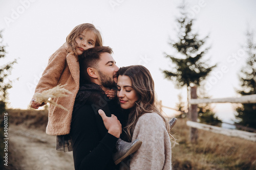 Fotografie Stylish young family in the autumn mountains