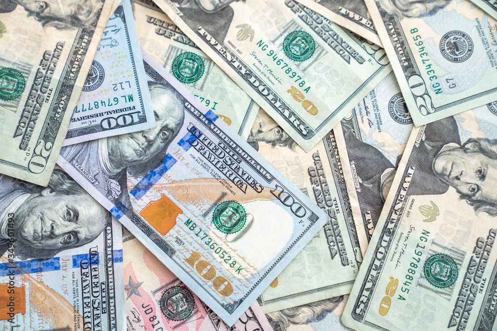 A background image closeup of american or united states paper currency or cash including hundred dollar bills, fifties and twenties making a great financial or economic backdrop wallpaper. A background image closeup of american or united states paper currency or cash including hundred dollar bills, fifties and twenties making a great financial or economic backdrop wallpaper.