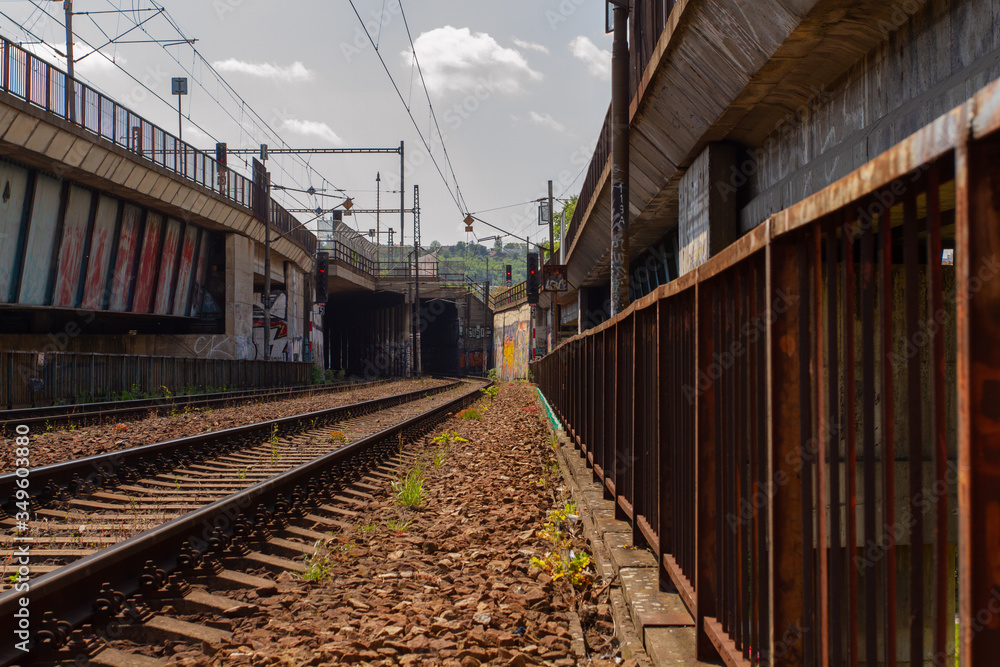 
old railway bridge for trains in the Czech city and tracks next to it