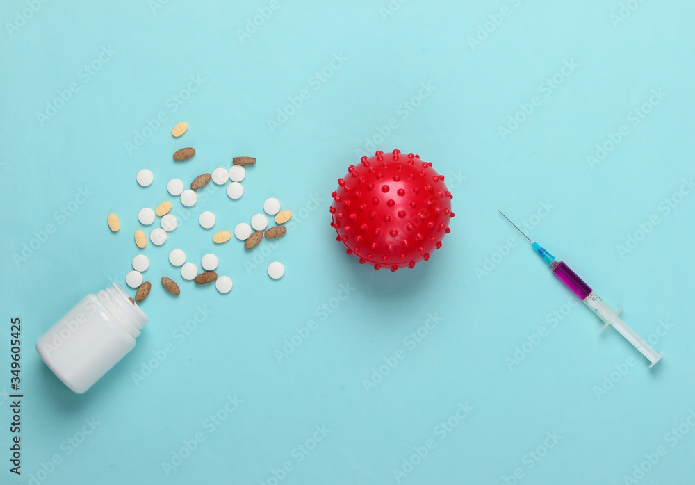 Coronavirus vaccine and treatment. Virus strain, syringe and pills on blue background. Vaccination. Medical concept. Pandemic Coronavirus vaccine and treatment. Virus strain, syringe and pills on blue background. Vaccination. Medical concept. Pandemic