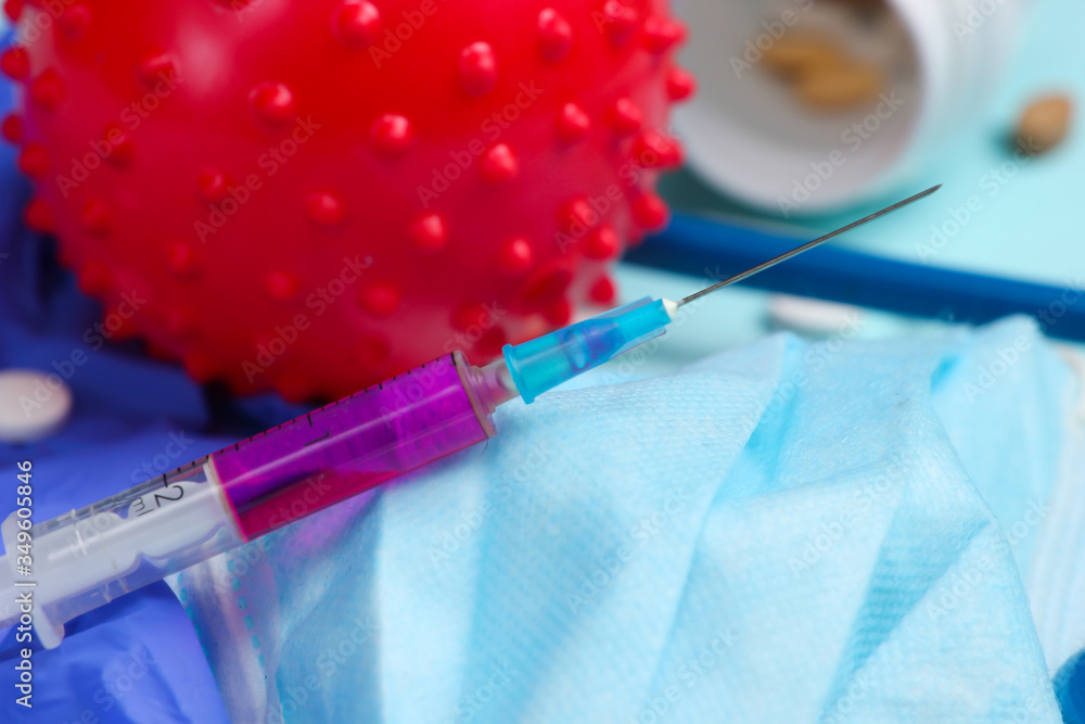 Syringe, medical supplies, virus strain on a blue background. Vaccination. Coronavirus; n-cov2019 Syringe, medical supplies, virus strain on a blue background. Vaccination. Coronavirus; n-cov2019