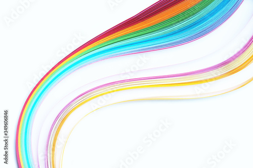 Quilling, strips of colored paper on white background, rainbow