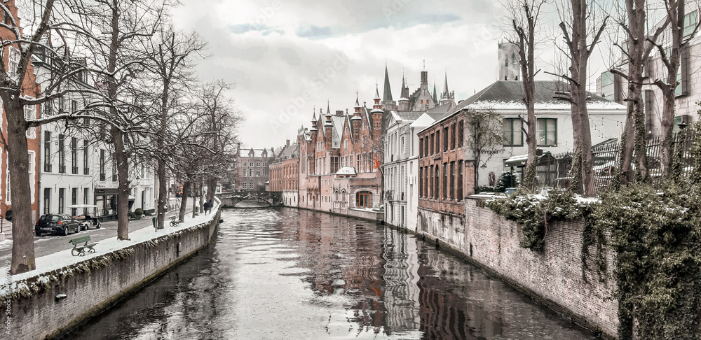 Panoramic city view with historical houses and watercourse in Bruges
