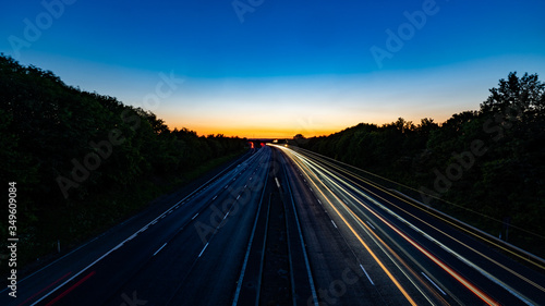 Light streaks shot of motorway with traffic flow on one side