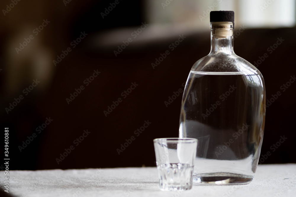 transparent decanter with a beautiful crystal glass on a dark background transparent decanter with a beautiful crystal glass on a dark background