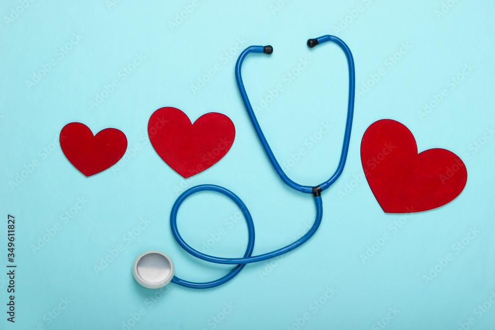 Stethoscope with hearts on a blue pastel background. Top view Stethoscope with hearts on a blue pastel background. Top view