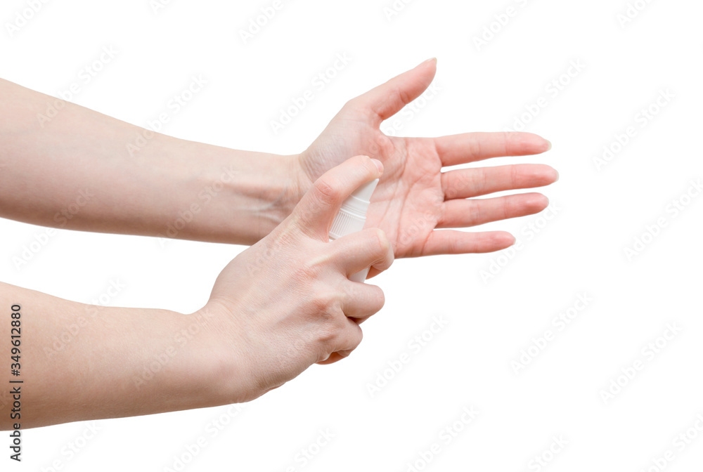 Woman is using spray sanitizer to desinfect her hands. Close up shot. Sude view.