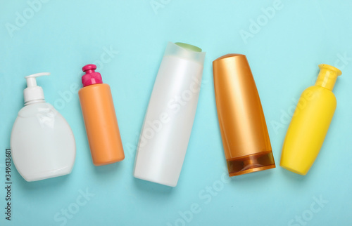 Shampoo bottles on blue pastel background. Hair care. Hygiene and cosmetics. Beauty flat lay. Top view