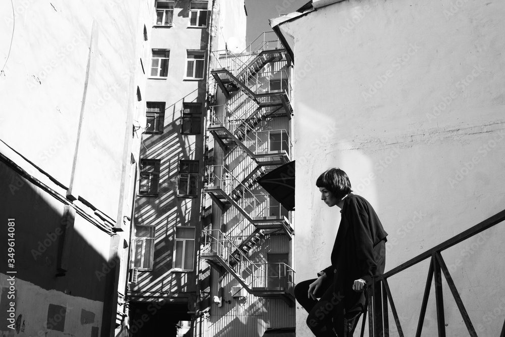 Fototapeta premium girl walks through the streets of the city, black and white photo