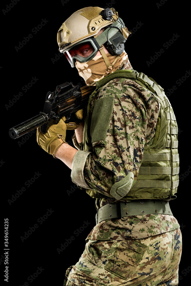Fototapeta premium US marine corps soldier with weapon. Shot in studio. isolated with clipping on black background.