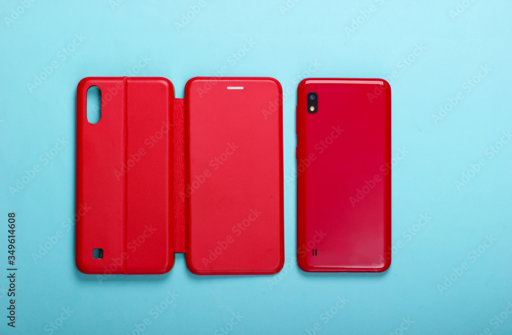 Smartphone with red leather protective case on a blue background Smartphone with red leather protective case on a blue background
