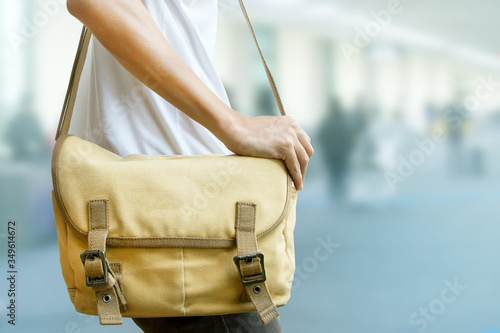 Man using shoulder bag for travelling