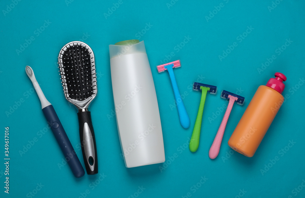 Female beauty products, hygiene accessories on blue background. Flat lay. Top view