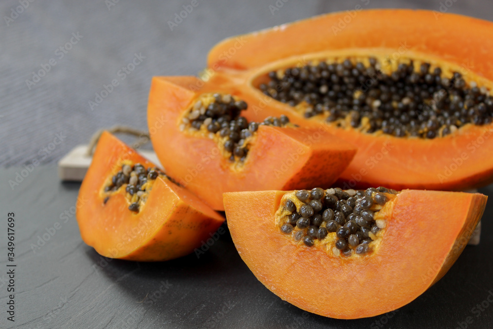 Papaya pieces on a grey background