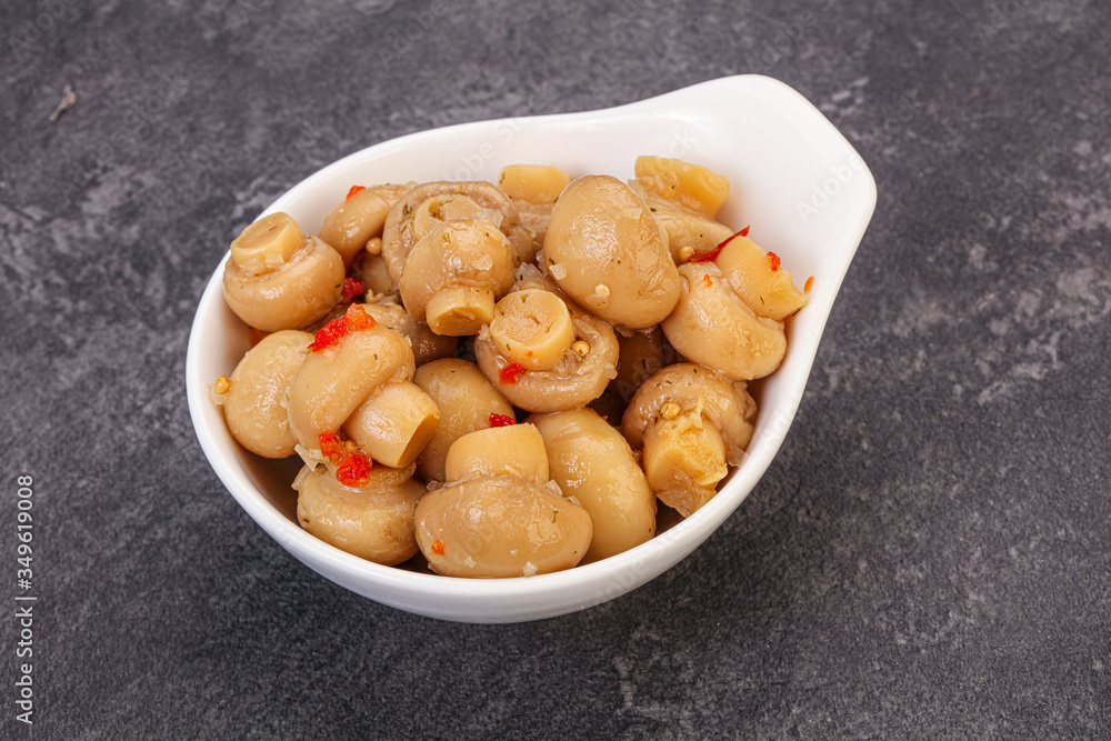Pickled champignons in the bowl