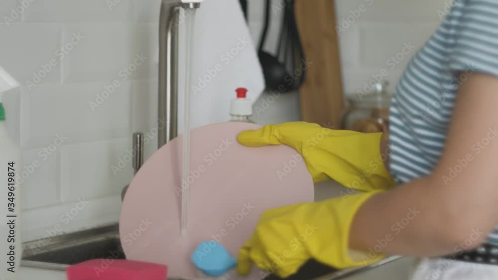 Woman washes a huge fish at kitchen Woman washes a huge fish at kitchen