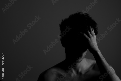 Young man teenager touching head hand curly hear